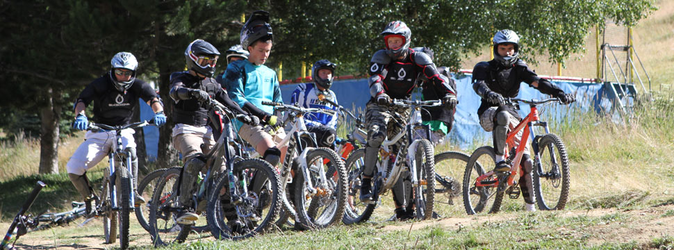 Un groupe de stagiaires adolescents prêts à dévaler le bike park à VTT